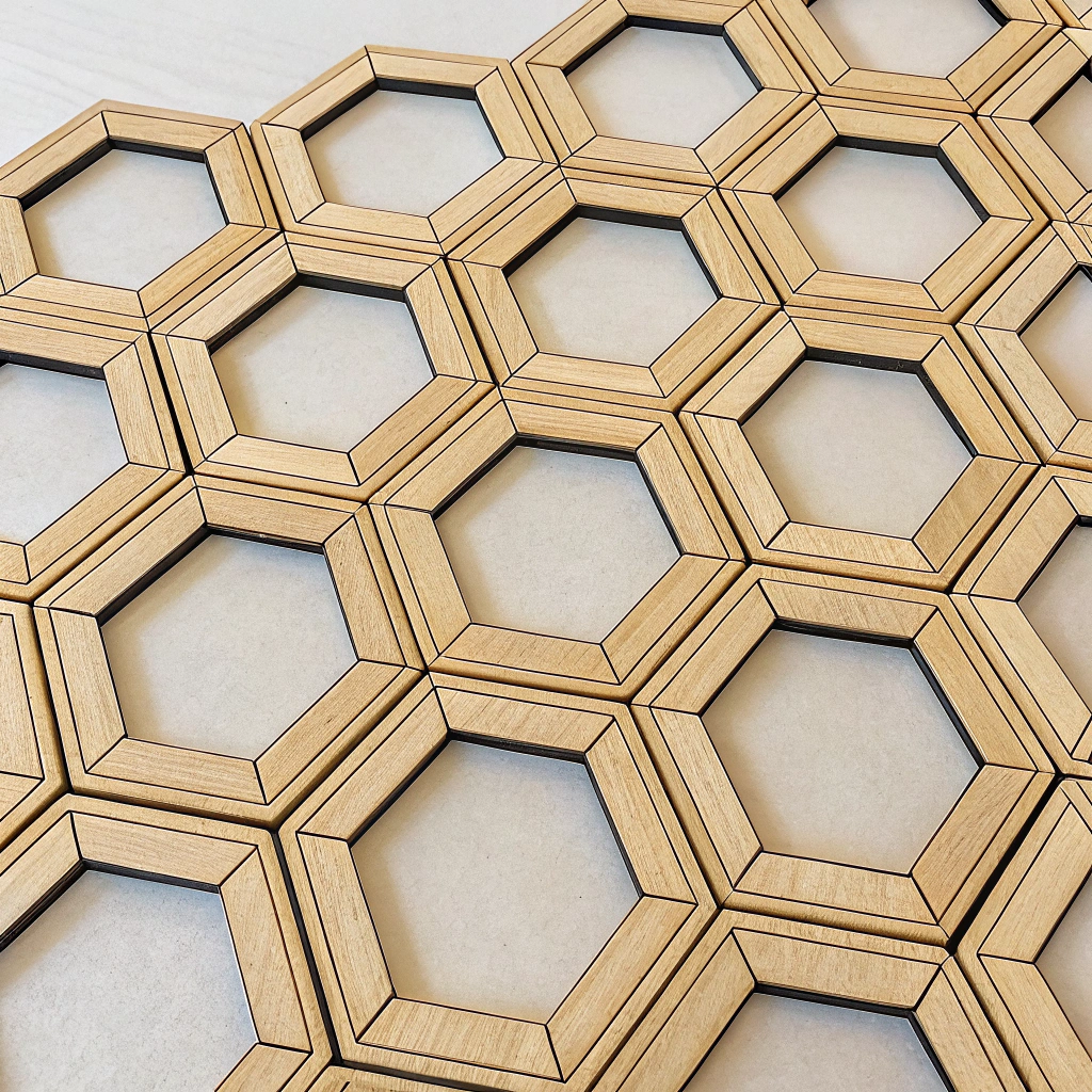 Design interlinking geometric modules (e.g., squares, hexagons) from sustainable materials that can be assembled into various adaptable products like furniture or storage, with the connection system itself forming a reusable pattern.